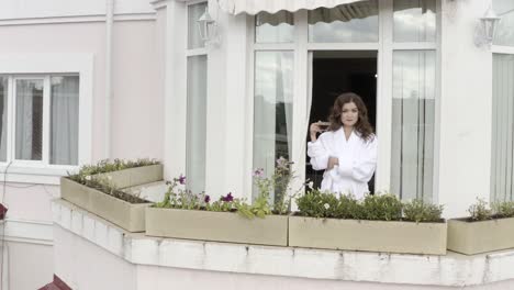 woman enjoying coffee on a hotel balcony