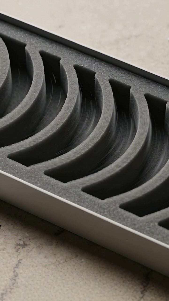 Vertical video: Panning camera revealing gray foam insert in tray on stone counter