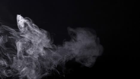 smoke over balck background. slow motion.