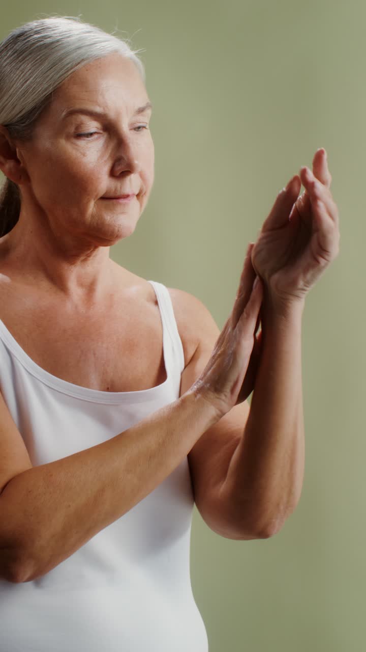 Senior Woman Applying Moisturizer