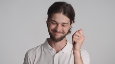 Caucasian-man-in-front-of-camera-on-gray-background.