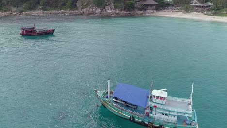 aerial view of a boat anchored in a tropical bay