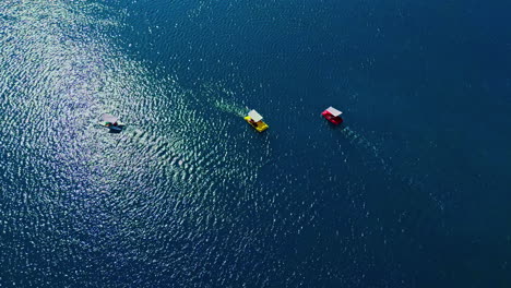 tourists paddling pedal boats on lake kournas