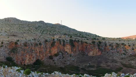 Custonaci-Sicily-Italy-crater-formation-in-the-province-of-Trapani,-Aerial-drone-pan-right-low-speed-motion