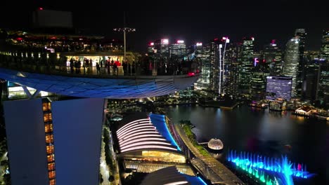 Marina-Bay-Gardens-at-night-showcases-the-stunning-skyline,-cityscape,-and-waterfront-reflections