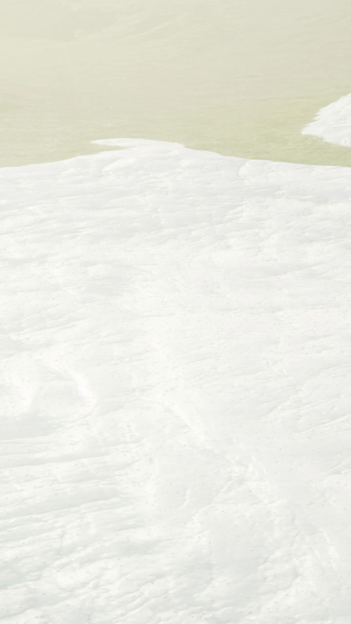 Snow covered landscape with gentle hills under soft sunlight in early morning