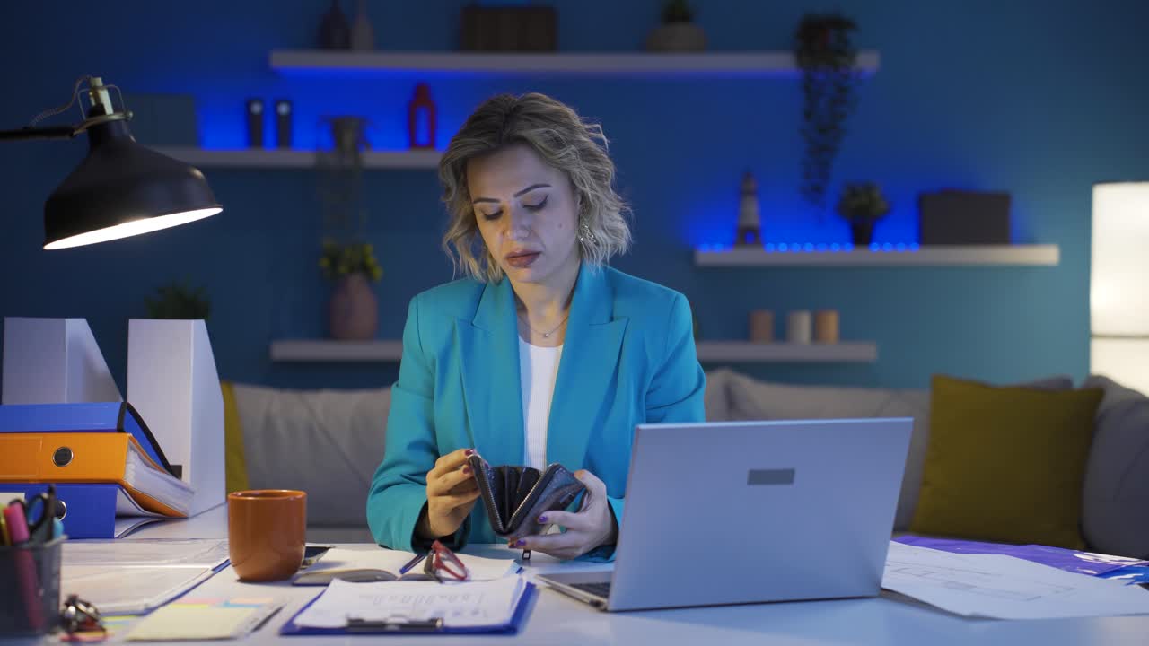 Home office worker woman showing her empty wallet to the camera.