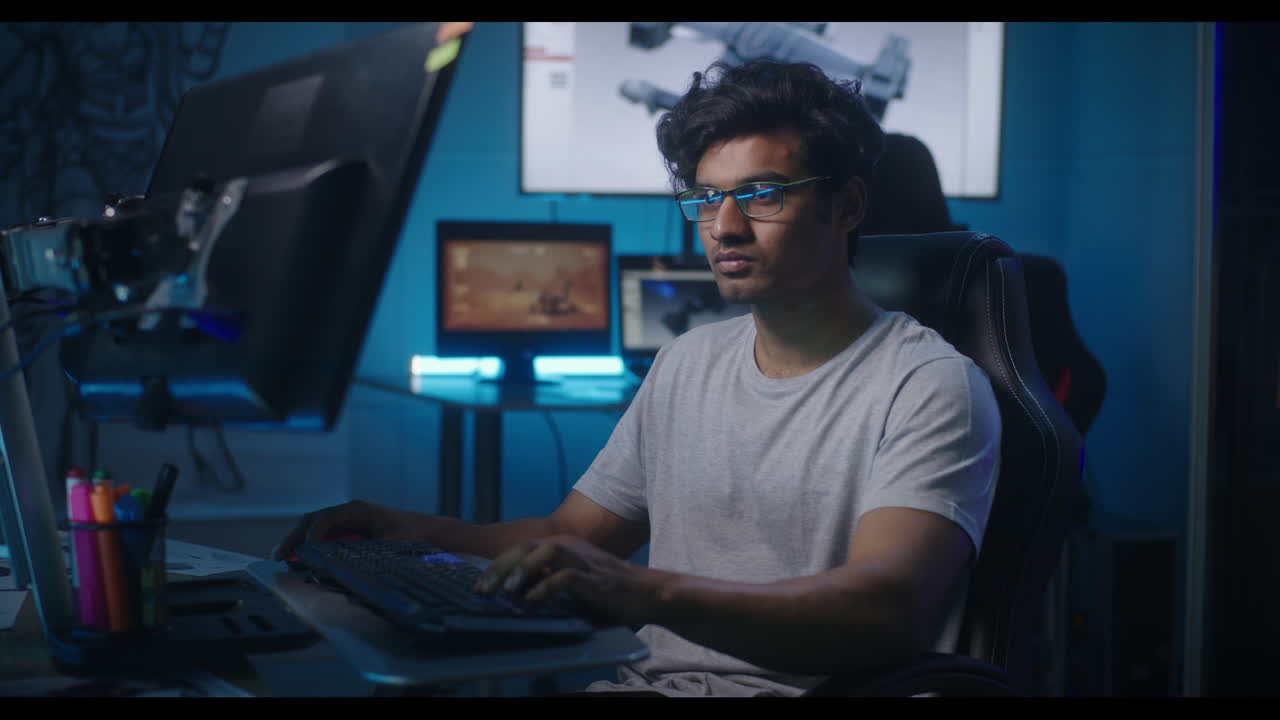 Person Working at a Computer in a Dark Room