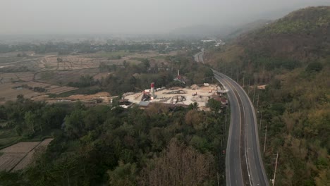 aerial view of a highway and rural landscape with an industrial site