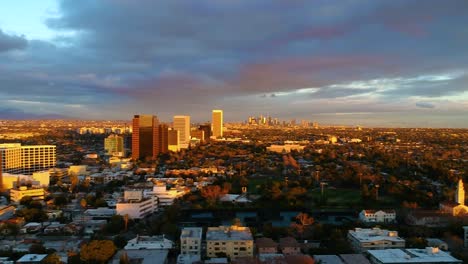 increíble vuelo sobre la ciudad durante el atardecer con el centro a lo lejos