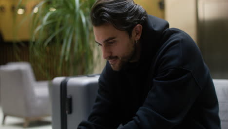 young man working on laptop at hotel hall