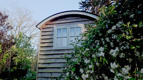 secluded rustic shepherds hut trailer abode hidden in garden bushes