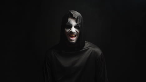 grim reaper with scary laughing over black background