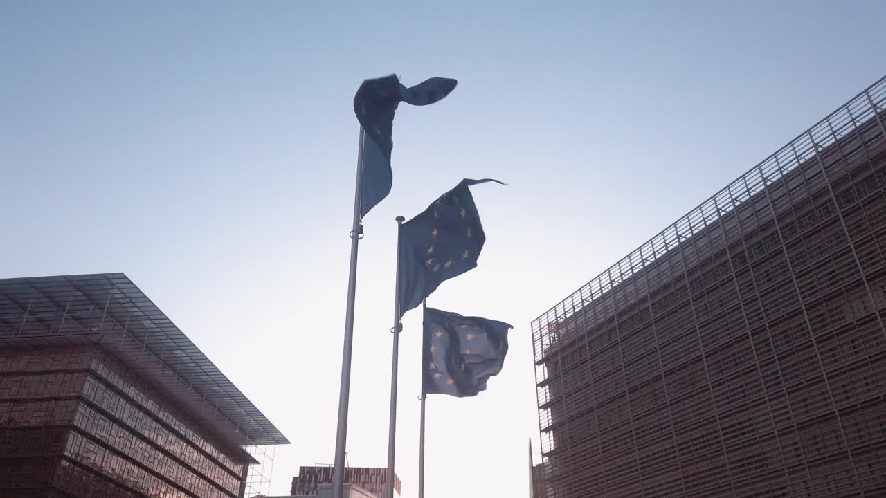 EU flags in front of the European Commission building in Brussels, Belgium