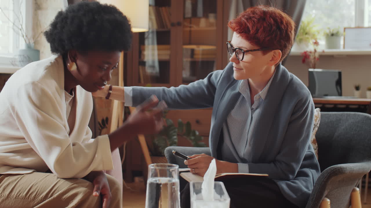 Psychologist Consoling Upset African American Woman on Therapy