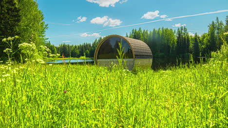 timelapse shot of an empty barrel sauna in rural countryside throughout the daytime in timelapse