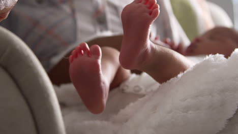 close up of parents cuddling newborn baby son in nursery