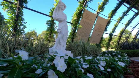 Female-Goddess-White-Statue-Around-Flowers-in-Botanical-Garden,-Curitiba-Brazil