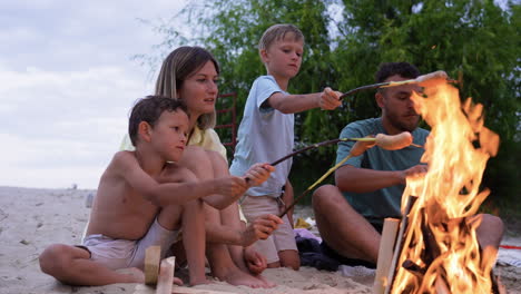 Familie-Isst-Würstchen-Am-Strand