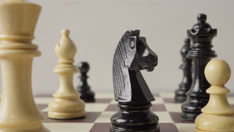 closeup of chess board as knight takes center stage in captivating rack focus