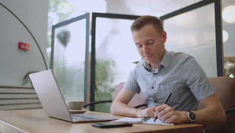 man college student using laptop computer watching distance online learning seminar class remote university webinar or having virtual classroom meeting in university creative space.