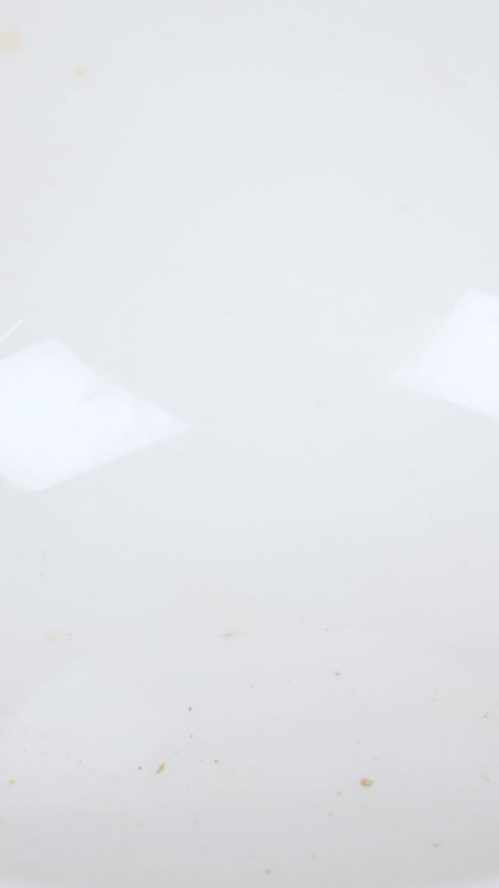 Peanuts gradually fill a white bowl