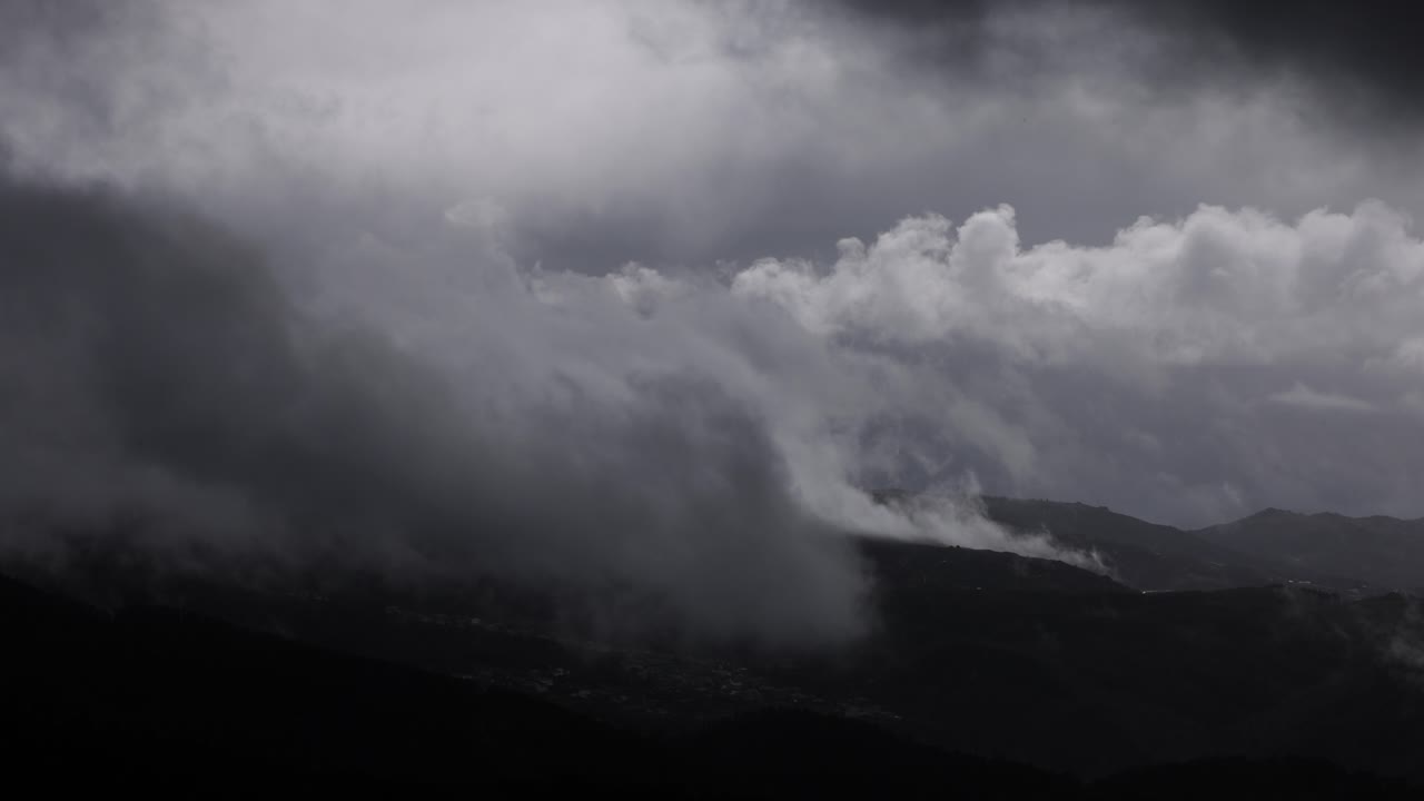 Timelapse of heavy rain clouds moving in the mountains on a stormy weather