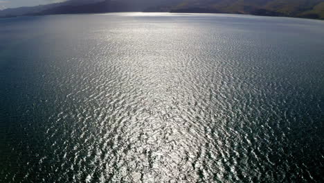 scenic bay landscape with shimmering water and distant hills