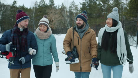 friends ice skating in winter park