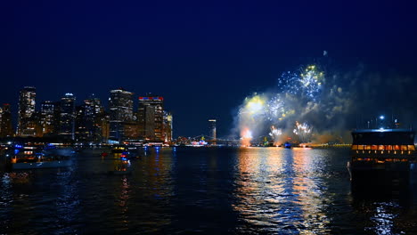 Spectacular firework show in the night sky of New York. Metropolis skyline and bridge at backdrop