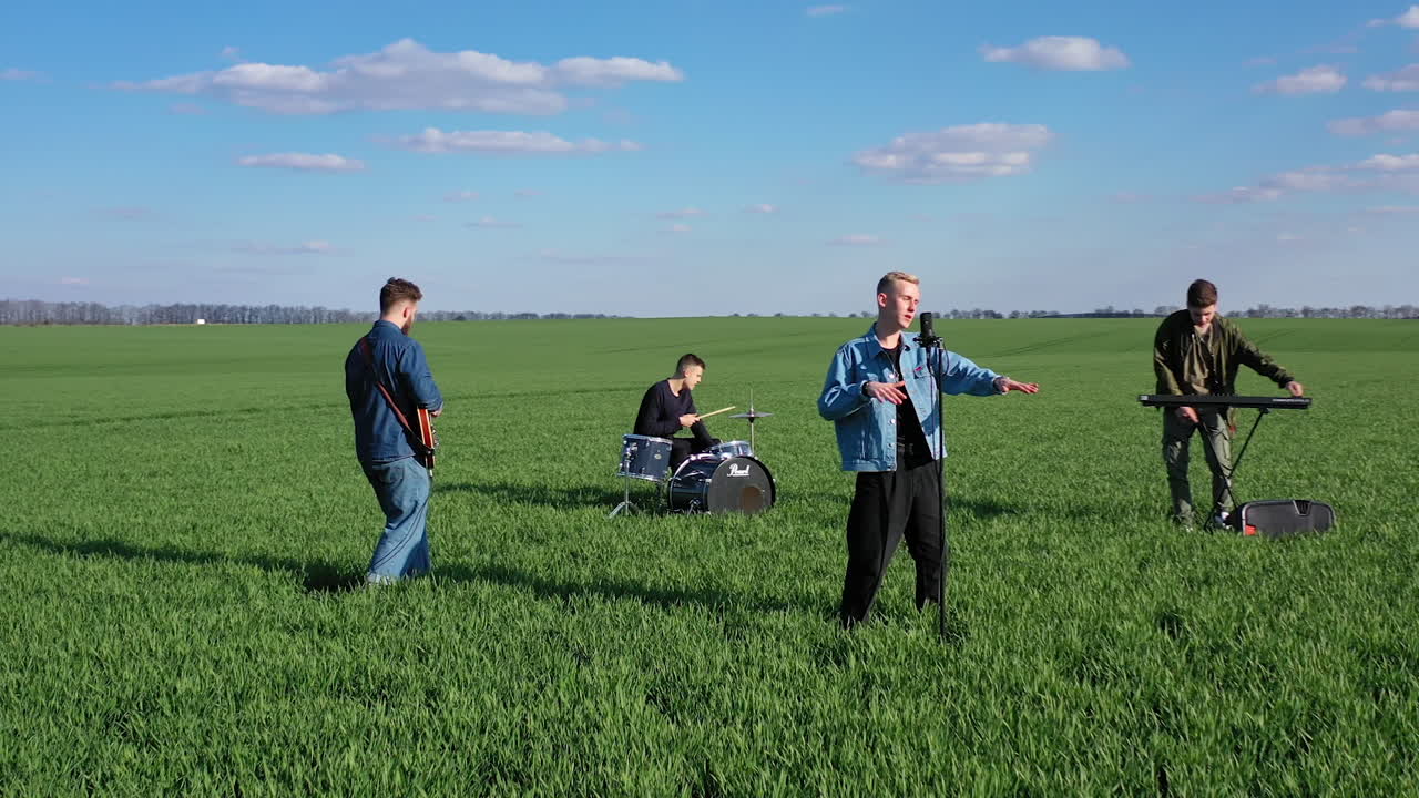Musical Group Playing Outdoors. Young band playing concert on field
