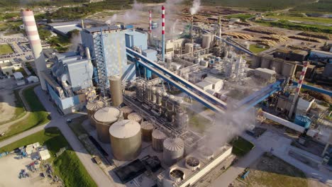 aerial view of a large industrial complex with smoke and steam rising from chimneys