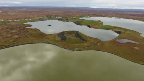 aerial drone shot flying over myvatn lake in iceland, medium flight altitude.