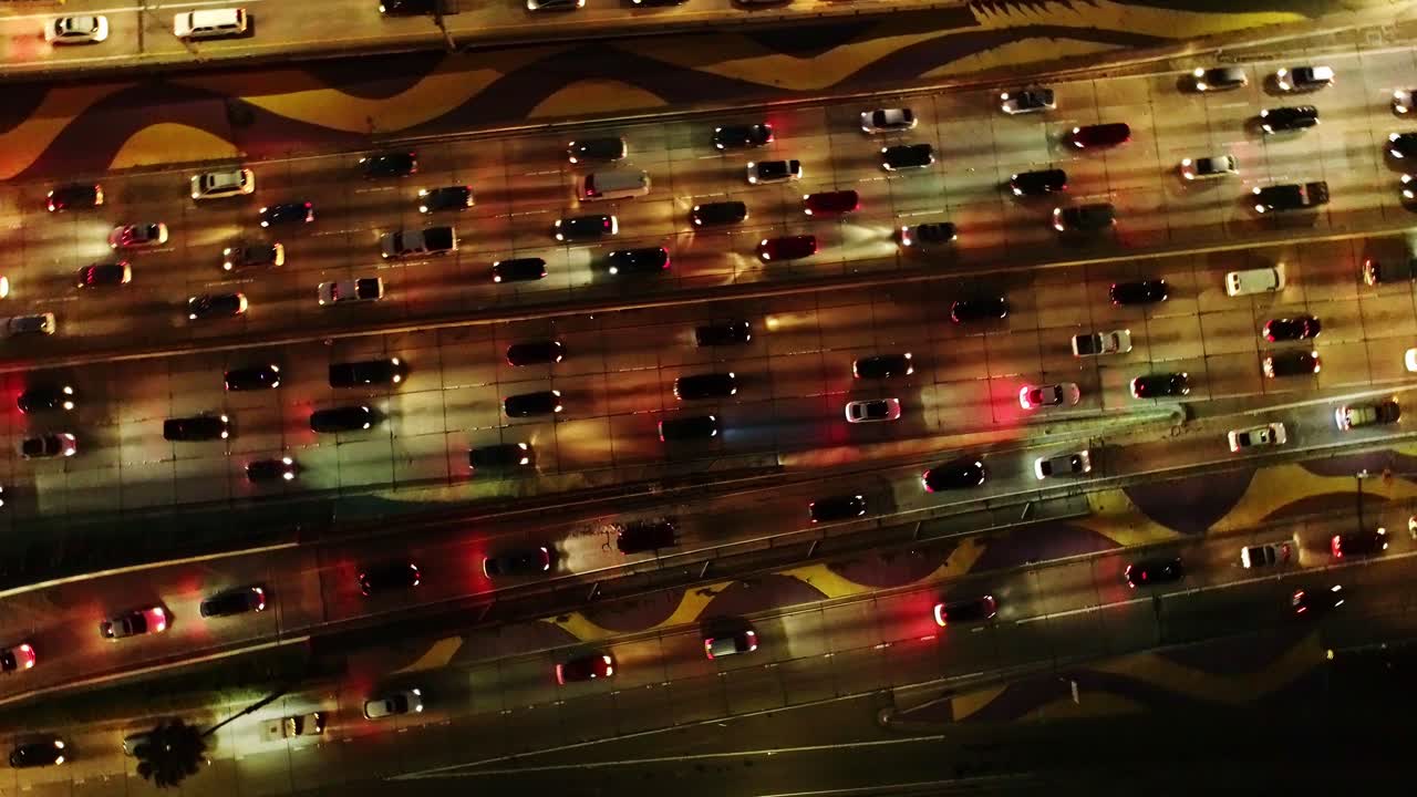 Aerial rotating shot of busy Los Angeles roads at night - intense traffic motion