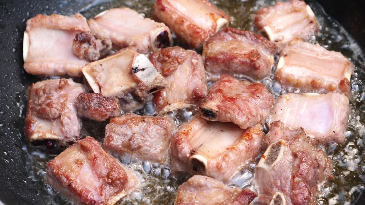 Iga babi goreng dalam wajan panas