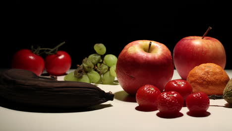 fruit decomposition timelapse against black background, panning right