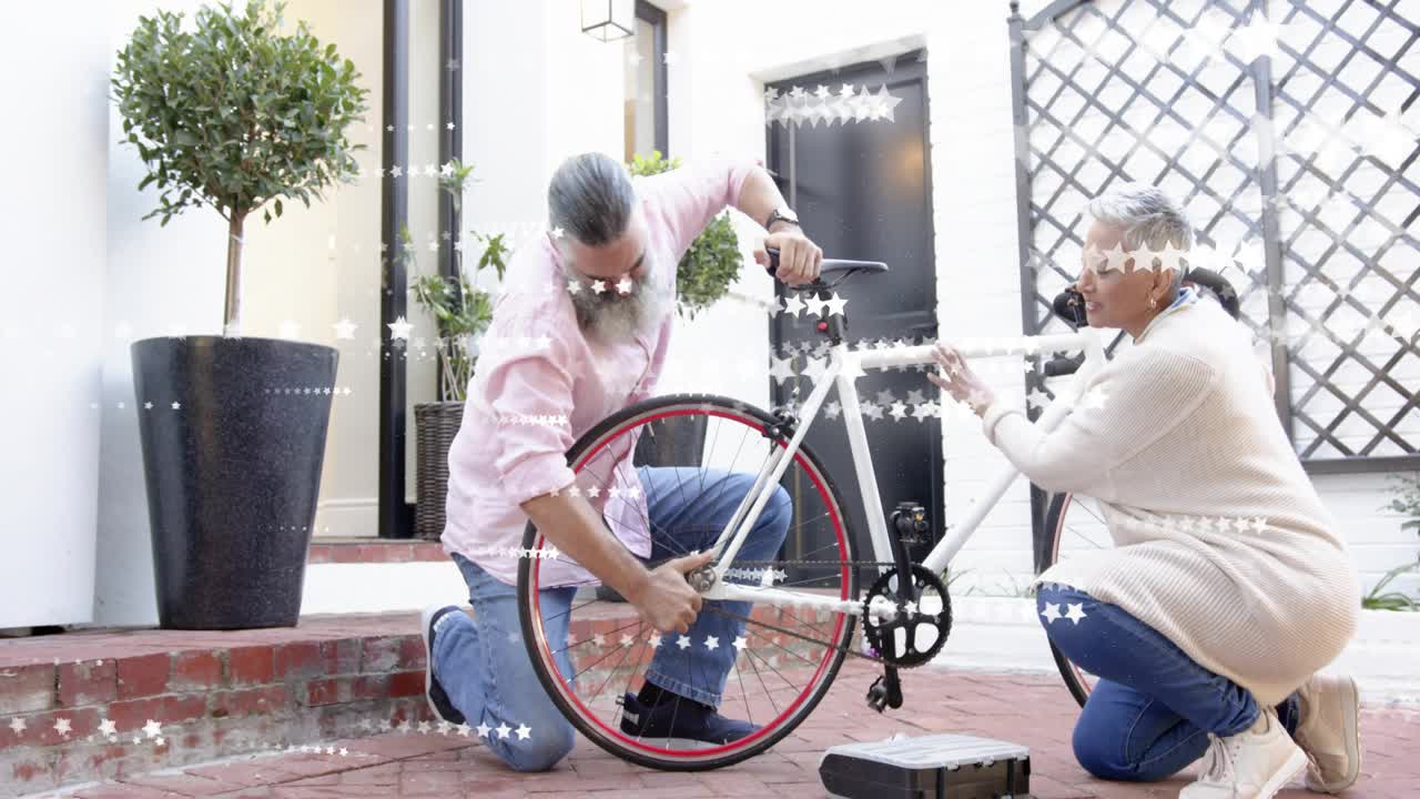Man and woman kneeling in courtyard, retrieving wrench and adjusting red-trimmed rear wheel for DIY