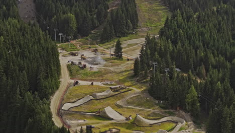 Whistler-BC-Canada-Aerial-v15-zoomed-birds-eye-view-drone-flyover-capturing-mountain-bike-park's-challenging-slopes,-uphill-lift-and-lush-forested-surroundings---Shot-with-Mavic-3-Pro-Cine---July-2023