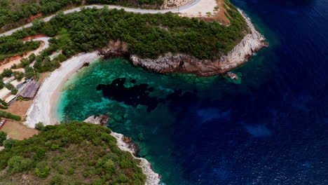 Aerial-drone-shot-of-Greek-Landscape-with-Turquoise-Sea-or-Ocean-Bay-and-Empty-Sand-Beach