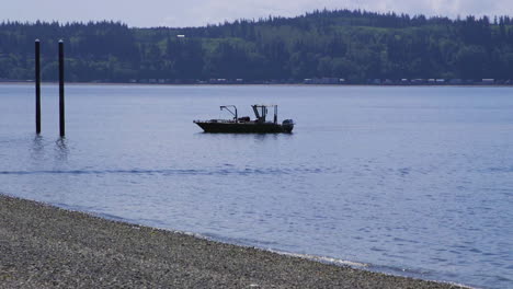 small, nondescript fishing floating near dock at camano island state park, wa state 20sec-24fps slow motion