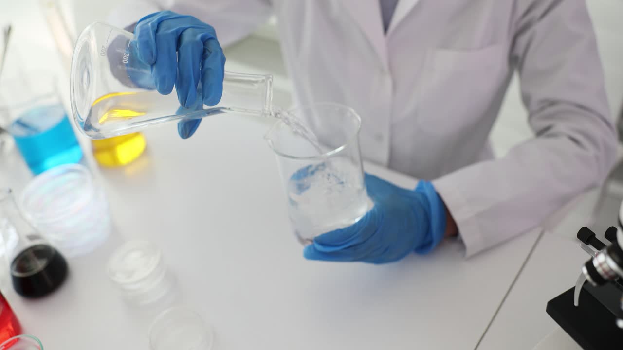 Scientist pouring liquid in a lab