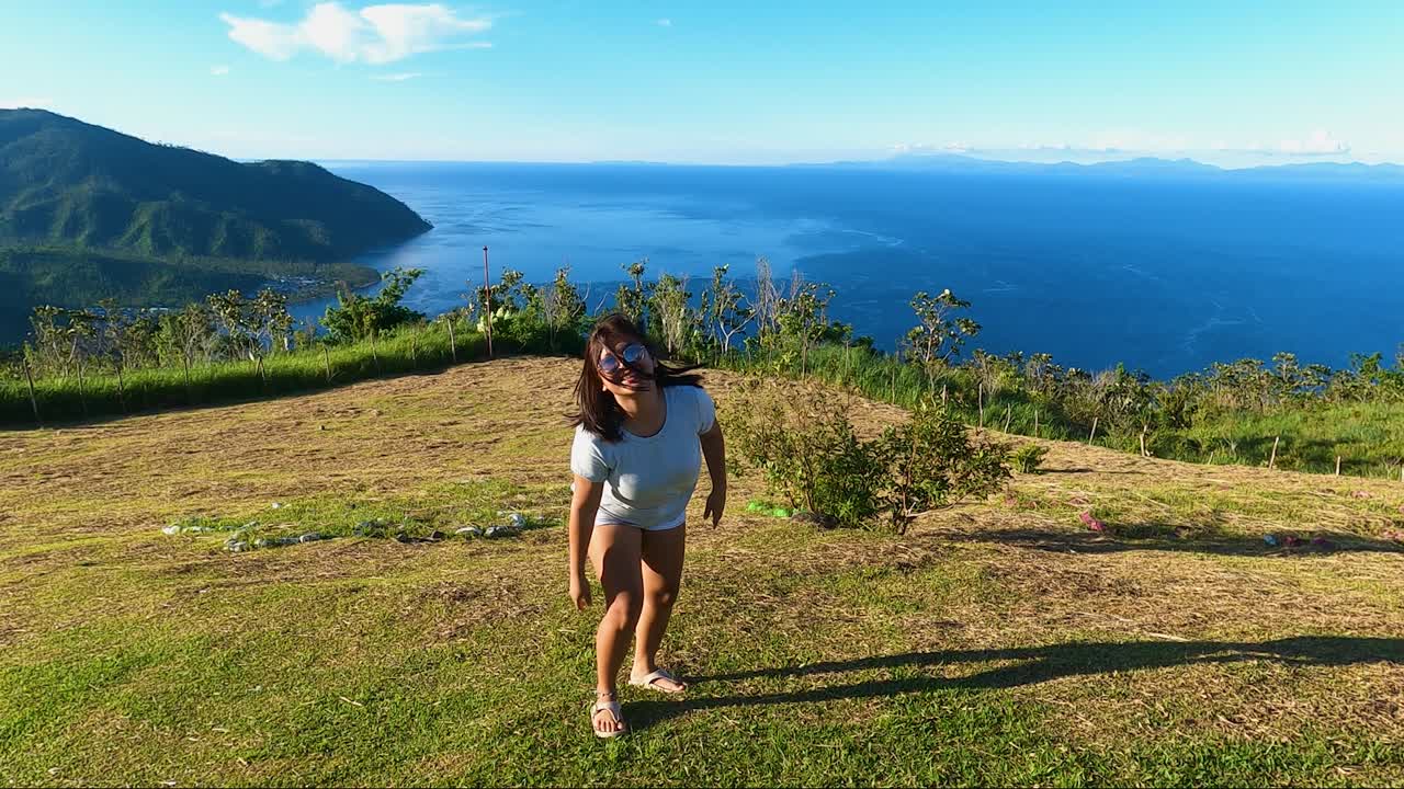 Chubby Asian Woman Having Fun On Mountain Park With Seascape And Island Overview In The Philippines. slow motion