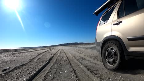 suv races across bahia asuncion baja mexico beach overlanding on sandy tracks on a birght sunny day