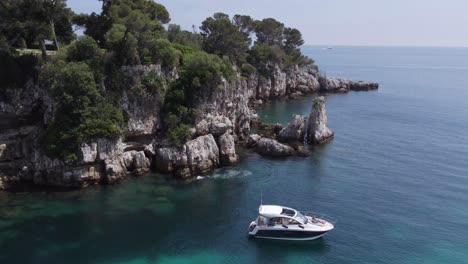 Boat-on-Mediterranean-Sea-Coastline-of-Antibes,-South-of-France---Aerial