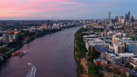 aerial view of toowong buildings and river in brisbane, queensland, australia during sunset - drone shot