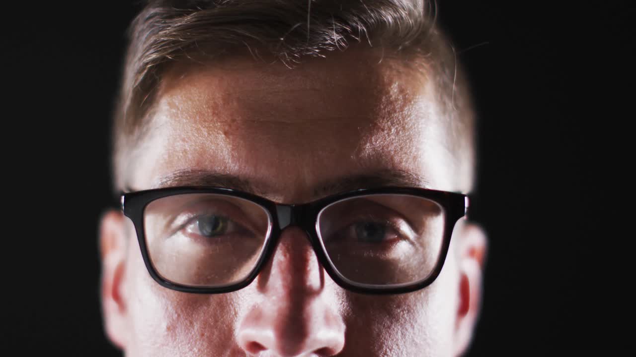 Close up portrait of face of caucasian man wearing glasses with focus on eyes