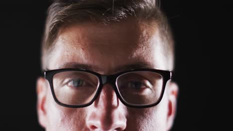 Close-up-portrait-of-face-of-caucasian-man-wearing-glasses-with-focus-on-eyes