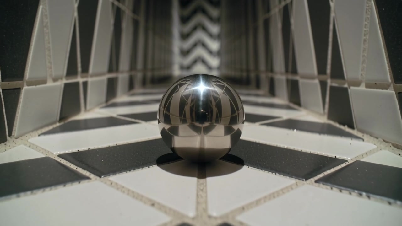 Pushing camera, reflective sphere appearing larger on tiled channel, emphasizing depth