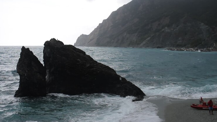 Coastal Scene with Rocks, Sea, and Mountains