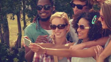 In-high-quality-format-happy-friends-in-the-park-taking-selfie-